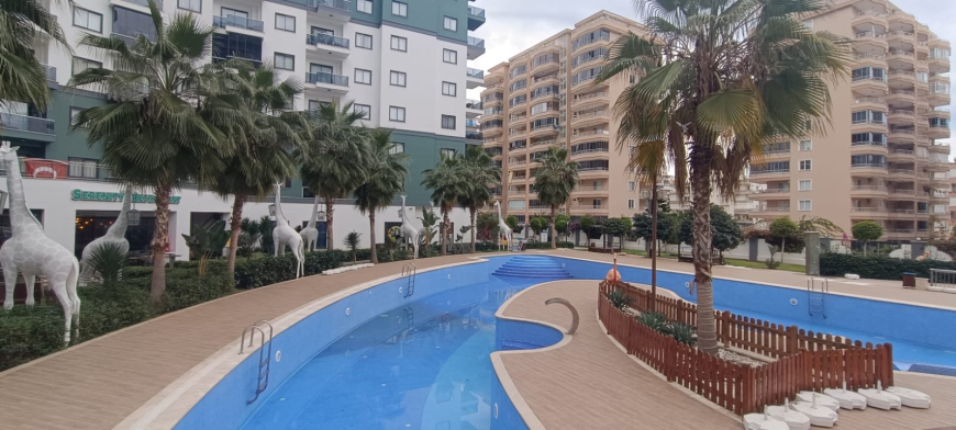 Меблированная 1+1 рядом с морем и полным отельным сервисом в центре Махмутлара