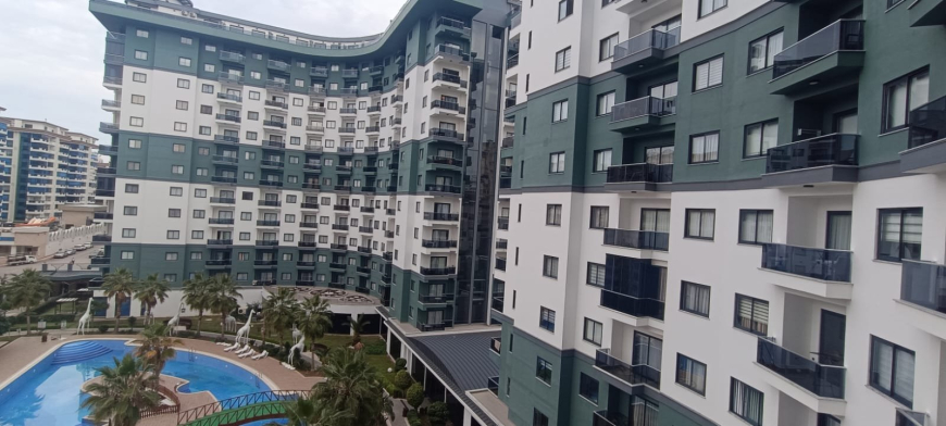 Меблированная 1+1 рядом с морем и полным отельным сервисом в центре Махмутлара