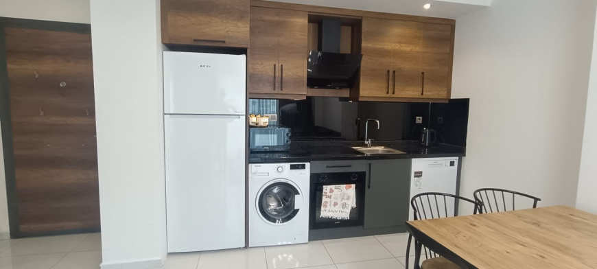 Меблированная 1+1 рядом с морем и полным отельным сервисом в центре Махмутлара