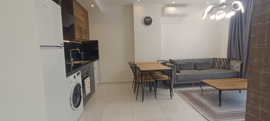 Меблированная 1+1 рядом с морем и полным отельным сервисом в центре Махмутлара