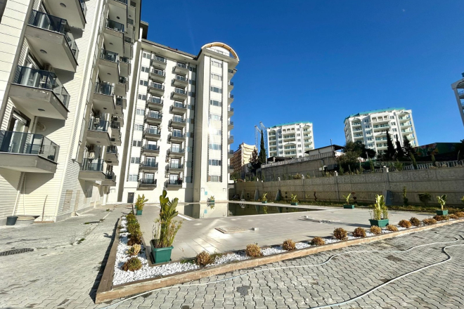 Новая 1+1 в Авсалларе с видом на город и природное окружение