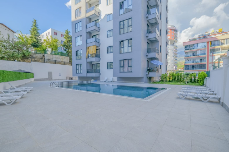 Светлая квартира с панорамными видами в новом доме Махмутлара для жизни и аренды