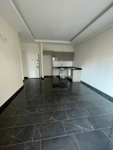 Новая квартира 1+1 с полной инфраструктурой в Махмутларе для жизни и дохода