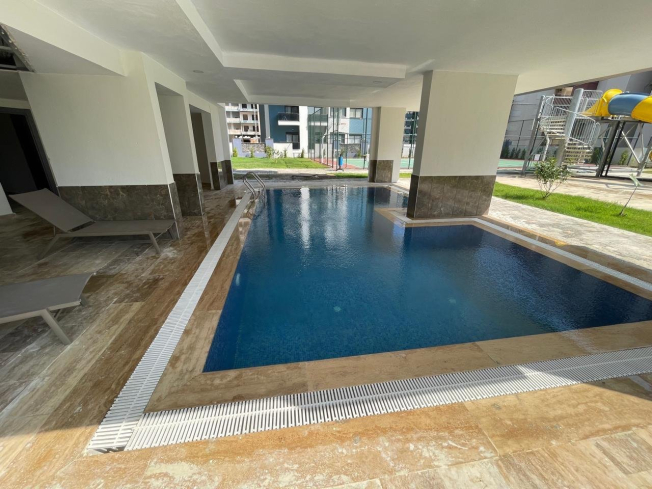 Современная 1+1 квартира в Махмутларе с расширенной инфраструктурой для отдыха